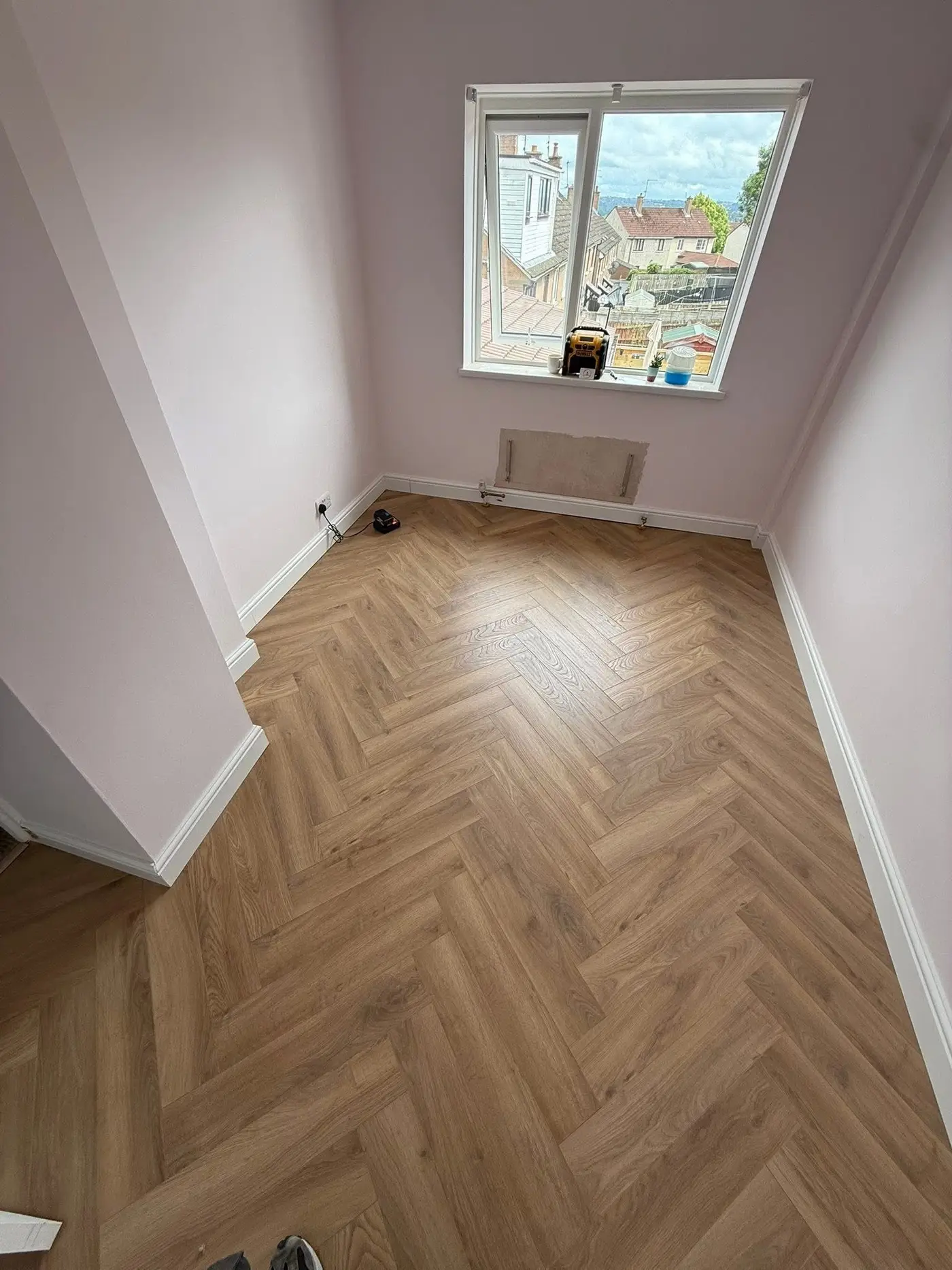 Living room with grey oak effect laminate flooring installed by The Flat Pack Man NI