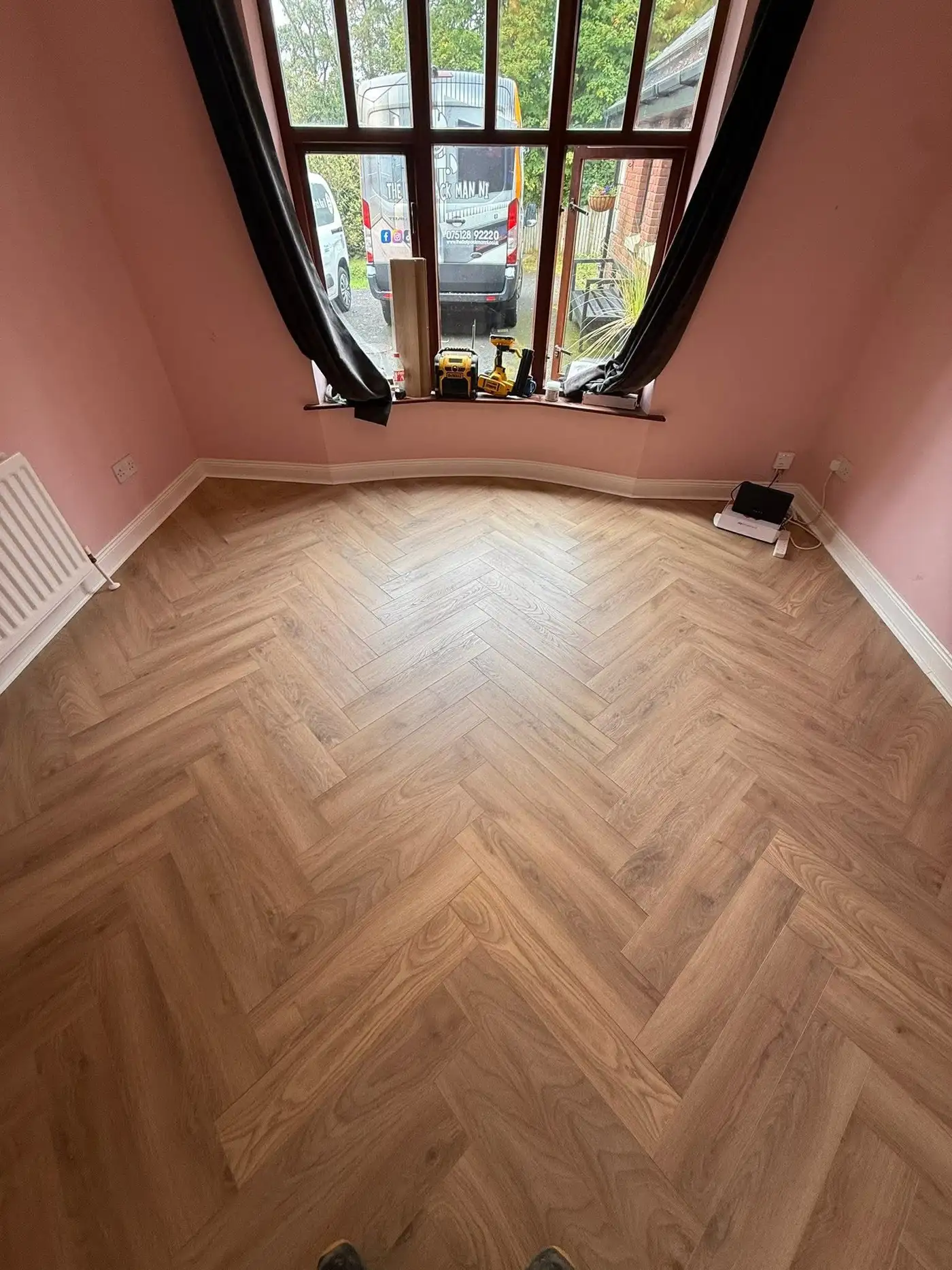 Living room with grey oak effect laminate flooring installed by The Flat Pack Man NI