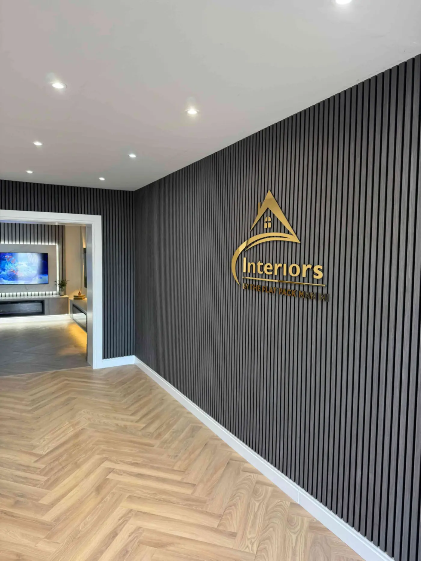 Interior showroom entrance sign in Bangor featuring modern wall paneling and feature walls