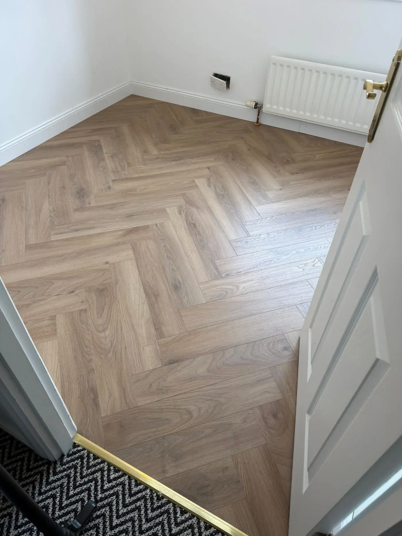 Living room with grey oak effect laminate flooring installed by The Flat Pack Man NI