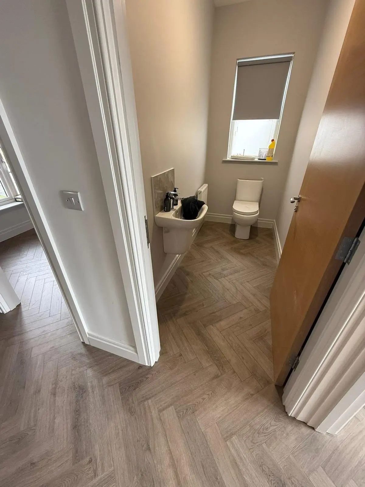 Living room with grey oak effect laminate flooring installed by The Flat Pack Man NI